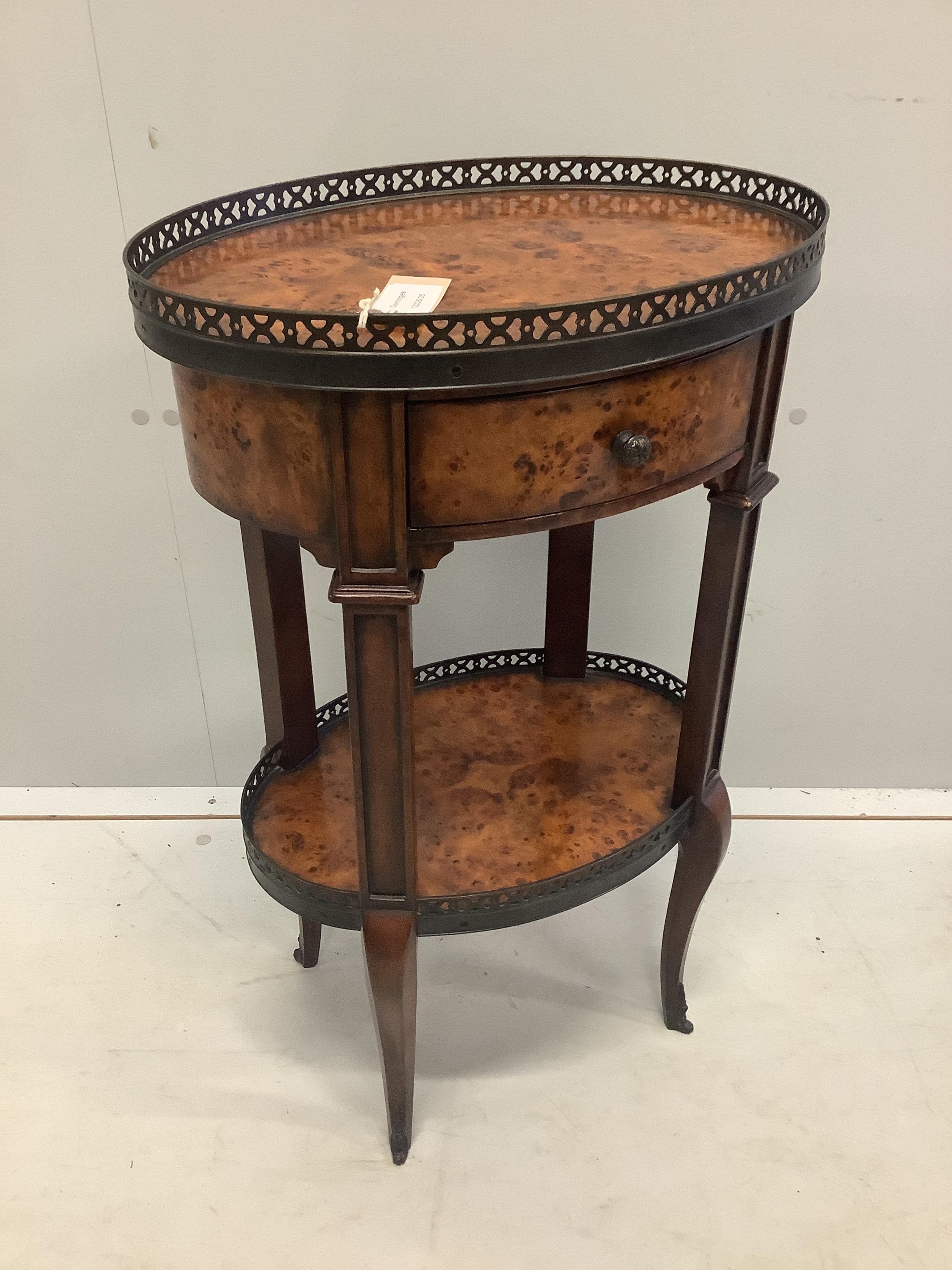 A Theodore Alexander oval bird's eye maple two tier table, width 44cm, depth 31cm, height 70cm